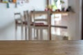 Wooden table desk in the front with blurry background Royalty Free Stock Photo