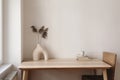 Wooden table, desk near window. Modern organic shaped vase with dry flowers, grass. Cup of tea, coffee, old books