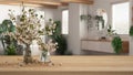 Wooden table, desk or shelf close up with branches of cherry blossoms in glass vase over blurred view of modern bathroom with