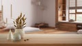 Wooden table, desk or shelf close up with ceramic and glass vases with dry plants, straws over blurred view of minimalist bathroom Royalty Free Stock Photo