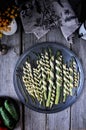 On a wooden table in a dish, asparagus baked in a dough