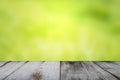 Wooden table with empty space. Has a green background, blurred and bokeh