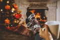 Wooden table with empty space for products and decorations. Blurred fireplace and christmas tree interior background. Royalty Free Stock Photo