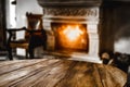 Wooden table with empty space for products and decorations. Blurred fireplace and christmas tree interior background. Royalty Free Stock Photo