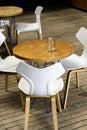 Wooden table with empty white chairs