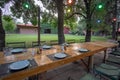 Set table and ivy covered buildings in background Royalty Free Stock Photo