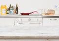 Wooden table in focus over blurred baking ingredients on kitchen Royalty Free Stock Photo