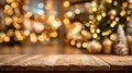 Wooden table foreground with blurred Christmas tree and festive decorations in the background, creating a warm and Royalty Free Stock Photo