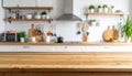 Wooden table in foreground with blurred modern kitchen background blurred background Royalty Free Stock Photo