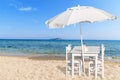 Wooden table with four chair on beautiful sandy beach and blue s Royalty Free Stock Photo