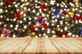 Wooden Table in Front of Blurred Christmas Tree Lights Background Royalty Free Stock Photo