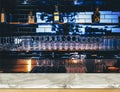 Wooden table in front of abstract blurred restaurant lights background of bar Royalty Free Stock Photo