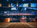 Wooden table in front of abstract blurred restaurant lights background of bar Royalty Free Stock Photo