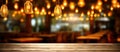 Wooden table in front of abstract blurred restaurant lights background