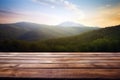 Wooden table in front of beautiful mountain landscape blurred background. Royalty Free Stock Photo