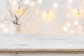 Wooden table in front of blurred abstract winter holiday background