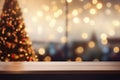 Wooden table in front of blurred background with Christmas tree and bokeh Royalty Free Stock Photo