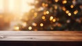 Wooden table in front of blurred christmas tree with bokeh lights Royalty Free Stock Photo