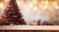 Wooden table in front of blurred christmas tree with bokeh lights Royalty Free Stock Photo