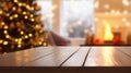 Wooden table in front of blurred Christmas tree with bokeh lights Royalty Free Stock Photo