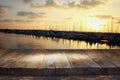 wooden table in front of blurred yachts in pier at sunset