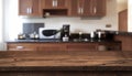 Wooden table in front of defocused modern kitchen counter top Royalty Free Stock Photo