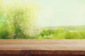 wooden table in front of spring cherry blossoms tree