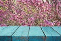 wooden table in front of spring cherry tree Royalty Free Stock Photo