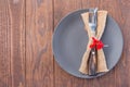 Wooden table with gray plate and fork and knife with autumn decoration, horizontal, top view, copy space Royalty Free Stock Photo