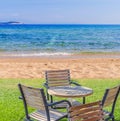 Wooden table on a green grass with beach and sea background Royalty Free Stock Photo