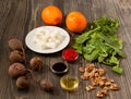 Wooden table of ingredients for beet salad with oranges and feta cheese