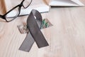 A gray ribbon on a wooden table.