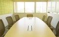 Wooden table in meeting room with sound absorbing wall sunlight through windows