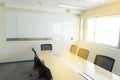 Wooden table in meeting room white board sunlight from window