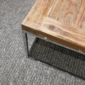 Modern wooden table on gray knitted carpet Royalty Free Stock Photo