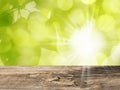 Wooden Table and Nature Background with Green Leaves and Sun Royalty Free Stock Photo
