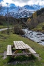 Wooden table near river in Gavarnie circus France autumn Royalty Free Stock Photo