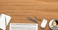 Wooden table with office supplies, top view