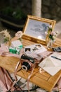 On a wooden table is an orange Fujifilm Instax Square SQ1 camera with spare film cartridges and instant photos Royalty Free Stock Photo