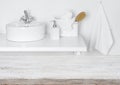 Wooden table over blurred domestic bathroom washbowl background Royalty Free Stock Photo