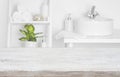 Wooden table over blurred spa salon bathroom shelves background