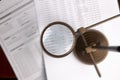 Magnifying glass and accounting reports of a company