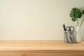 Wooden table with pencils and home decor plant Royalty Free Stock Photo