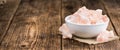 Wooden table with a portion of pink Salt