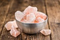 Wooden table with a portion of pink Salt