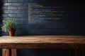 Wooden table with potted plant against a dark wall featuring colorful coding text at night