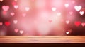 Wooden table on the red and pink festive background with soft heart shaped bokeh. St. Valentines backdrop.