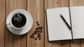 Wooden table. Scattered coffee beans add texture beside it. An open Royalty Free Stock Photo