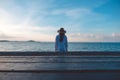 Wooden table with the sea and blue sky background and a blur woman