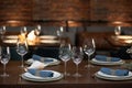 Wooden table served with plates, forks, spoons, glasses, napkins in the restaurant Royalty Free Stock Photo